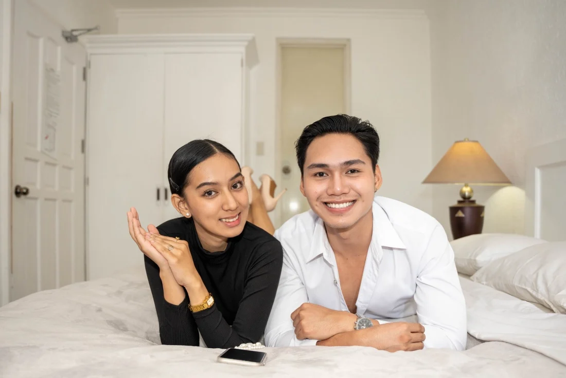 Happy guests relaxing in their hotel suite at Stonestown Suites